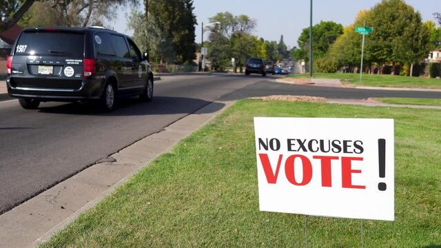 Election Voter Rally Sign Next to Road with Cars Driving By, No Excuses Vote!