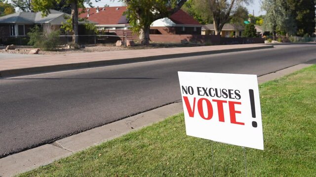 Election Voter Rally Sign Next to Empty Road with No Cars Driving By, No Excuses Vote! - Powered by Adobe