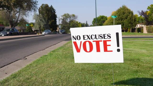 Election Voter Rally Sign Next to Road with Cars Driving By Close Up, No Excuses Vote! - Powered by Adobe