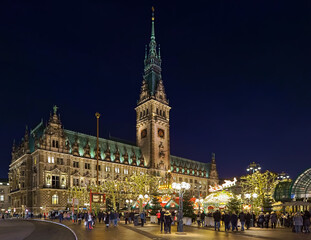 Hamburg, Germany. Christmas market at Town Hall square in front Hamburg Town Hall in dusk.
