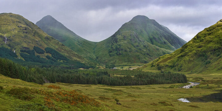 A menacing sky over the twin peaks of Stob Dubh and Stob na Broige, deep in the wilderness of beautiful Glen Etive in the Highlands of Scotland.