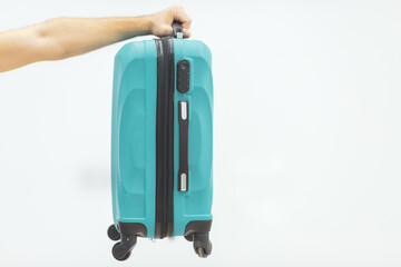 A hand holding suitcases isolated on white.