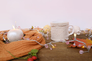 beverage, hot drink in a mug, leaves, foliage, garland, candles, top view of wooden table, good weather concept, outdoor tea party, cozy autumn mood