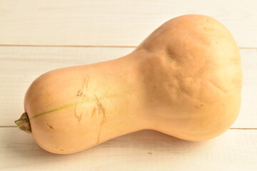 Ripe organic pumpkin, close-up, on a wrinkled table.