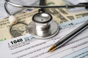 Tax Return form 1040 and dollar banknote, U.S. Individual Income.