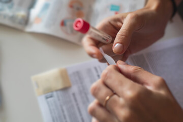 Process of coronavirus testing examination at home, COVID-19 swab collection kit, test tube for taking OP NP patient specimen sample, testing carried out, patient receiving a corona test