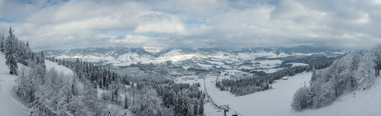 Aerial drone panorama of winter snowy Carpathians.
