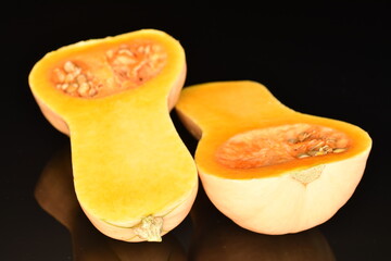 Ripe organic pumpkin, close-up, on a black background.