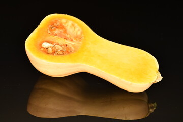 Ripe organic pumpkin, close-up, on a black background.