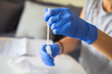 Process of coronavirus testing examination at home, COVID-19 swab collection kit, test tube for...