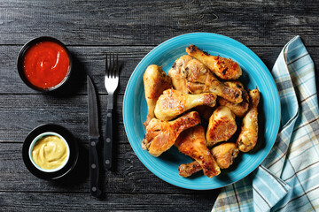 Spicy chicken drumsticks with ketchup and mustard