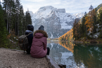 A couple looking at the lake and the mountains.