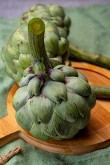 Big ripe uncooked green globe artichoks vegetables