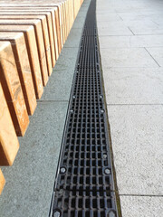 iron grate of water drain in grass garden field