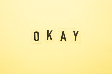 The word ok in black letters on a yellow background.