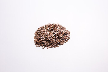 Closeup flax seeds on a white isolated background.
