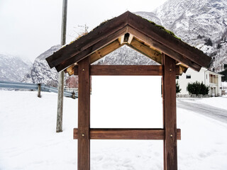 Empty wooden tourist information sign in winter in Norway.