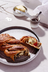 Swirl brioche with poppy seeds served with butter and jam. Poppy seed braided or roll bread, Babka. Traditional sweet Christmas bread