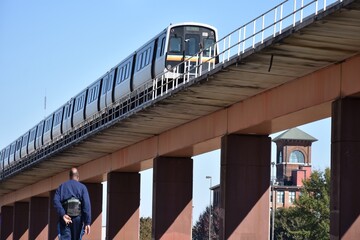 Mass transit train on an elevated track in the city - Powered by Adobe