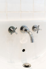 Ceramic Water tap sink with faucet with soap and towel in expensive loft bathroom or kitchen
