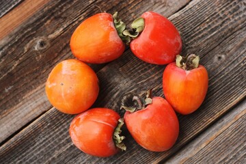 Ripe juicy persimmon on a wooden table