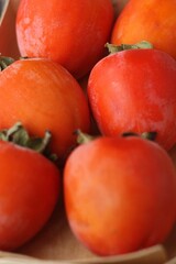 Ripe juicy persimmon on a wooden table