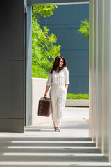 Traveler woman holding Vintage old classic travel suitcases.