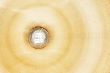 Unique lamp housing inside a coffee shop from below. Edison lamp is included in room.