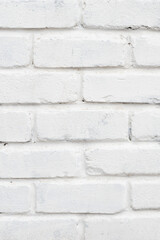 Abstract white brick wall textured background, vertical orientation, close-up