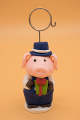 Christmas toy in the form of a pig isolated on yellow background