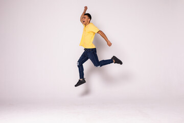 Happy excited young man jumping and celebrating success isolated on a white background