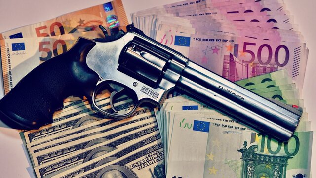 Revolver Smith e Wesson 357 magnum on a background of euro banknotes. concept of robbery, dirty money, crime