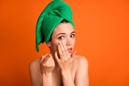 Photo Portrait Of Woman Putting Contact Lens In Pulling Eyelid Down Isolated On Vivid Orange Colored Background