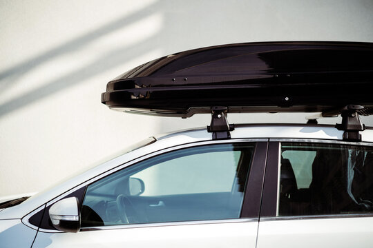 Large black plastic family car roof rack for travel.