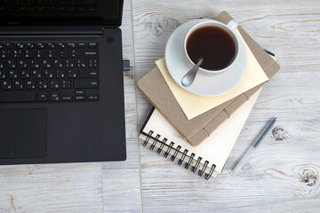 Office desk wood table of Business work place, notebook and coffee cup with copy space.