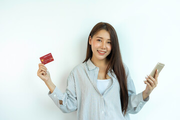 A beautiful smiling Asian woman holding a credit card. Lifestyle of the new generation Credit Card Spending Payment Confidence, Credit Card Spending Safety Concept
