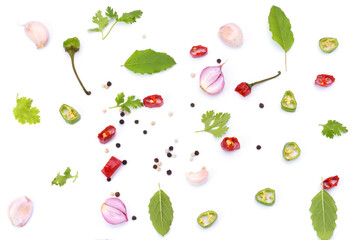 Pepper and red chillies, basil, garlic and spices isolated on white background - top view.