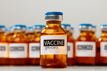 Sars-cov-2 vaccine vial bottles on white table