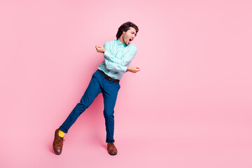 Full length photo portrait of guy dancing screaming isolated on pastel pink colored background with blank space