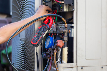 Air Conditioning Repair man hands checking and fixing modern air conditioning system, Technician team checking leakage air conditioning system