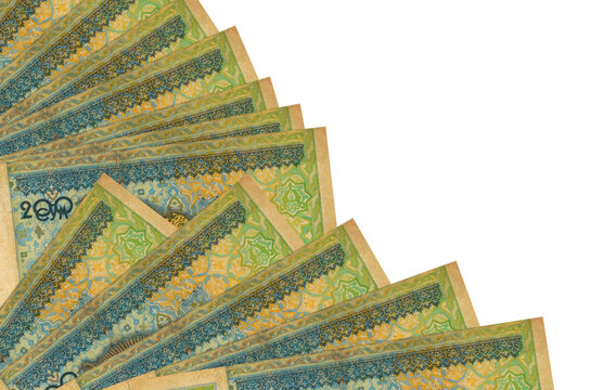 200 Uzbekistani som bills lies isolated on white background with copy space stacked in fan close up