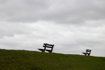 Park bench facing clouds Doel