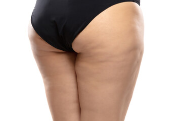 Fototapeta premium Back view. Overweight woman with fat cellulite legs and buttocks, obesity female body in black underwear isolated on white background. Orange peel skin, liposuction, healthcare and beauty treatment.