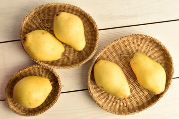 Ripe organic yellow-red pears, close-up, on a wooden table.