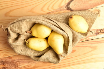 Ripe organic yellow-red pears, close-up, on a wooden table.