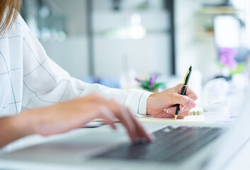 Business women keep records of statistics and company profits In the office to prepare for tomorrow morning meetings, business ideas and note-taking.