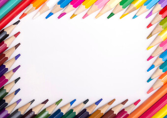 Color pencils on white background, top view with space for text or creativity.Frame