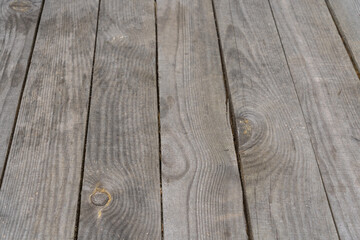 Closeup view photography of real wooden natural grey aged surface of rustic table with perspective angle shoot. Abstract wooden photo background.