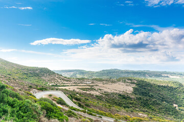 Winding country road under a blue sky in Sardinia