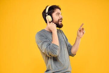 Man with headphones music lifestyle lifestyle technology yellow background